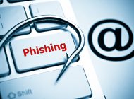 phishing / a fish hook on computer keyboard with email sign / computer crime / data theft / cyber crime